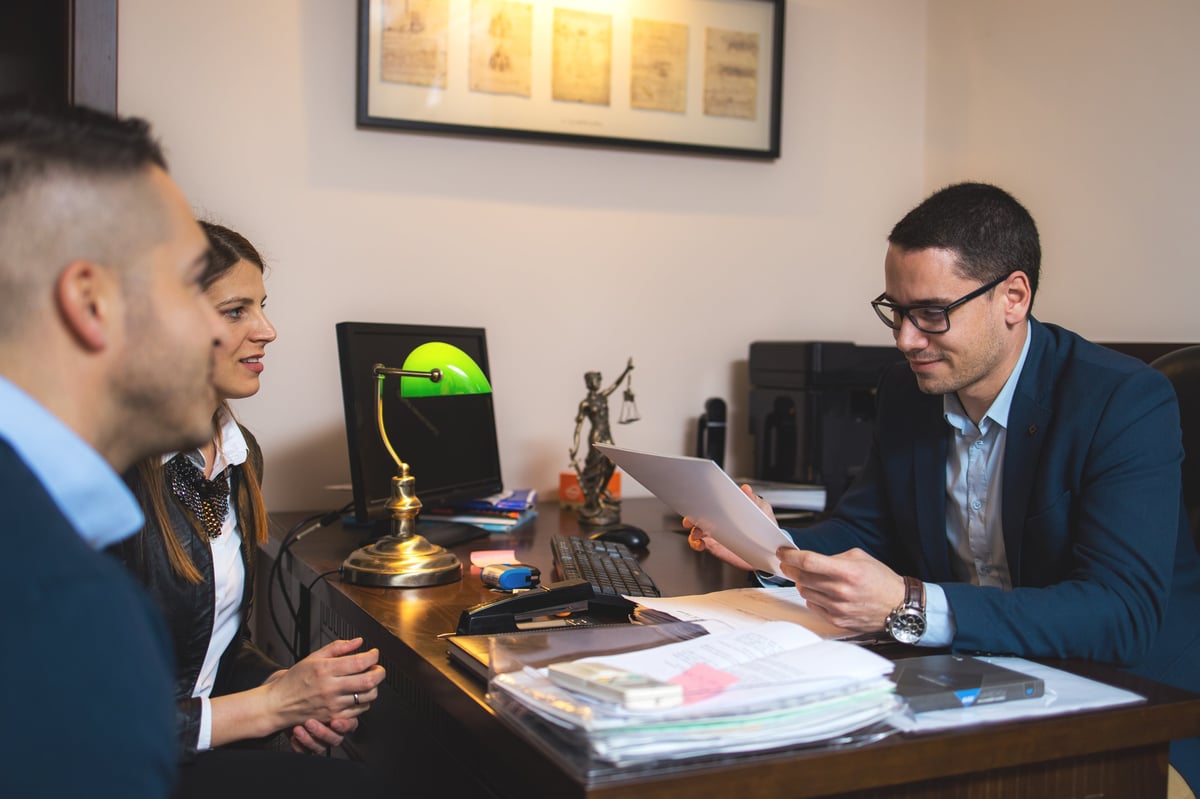 A couple reviewing a lease agreement with their agent