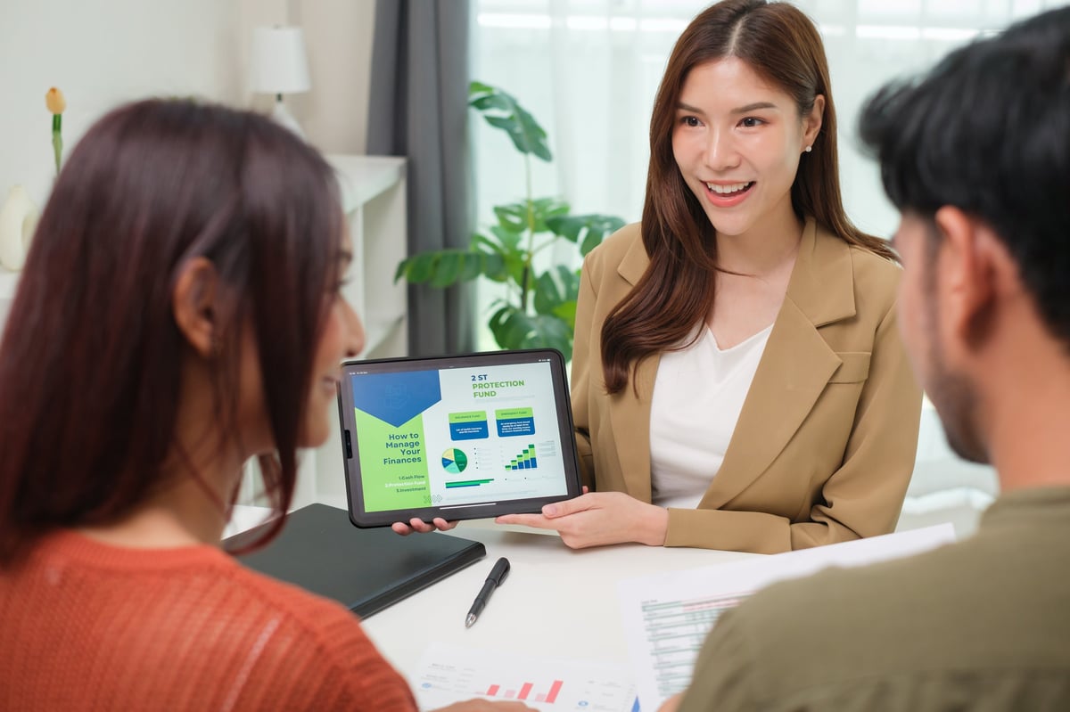 A financial advisor presenting analysis on a tablet during a client consultation